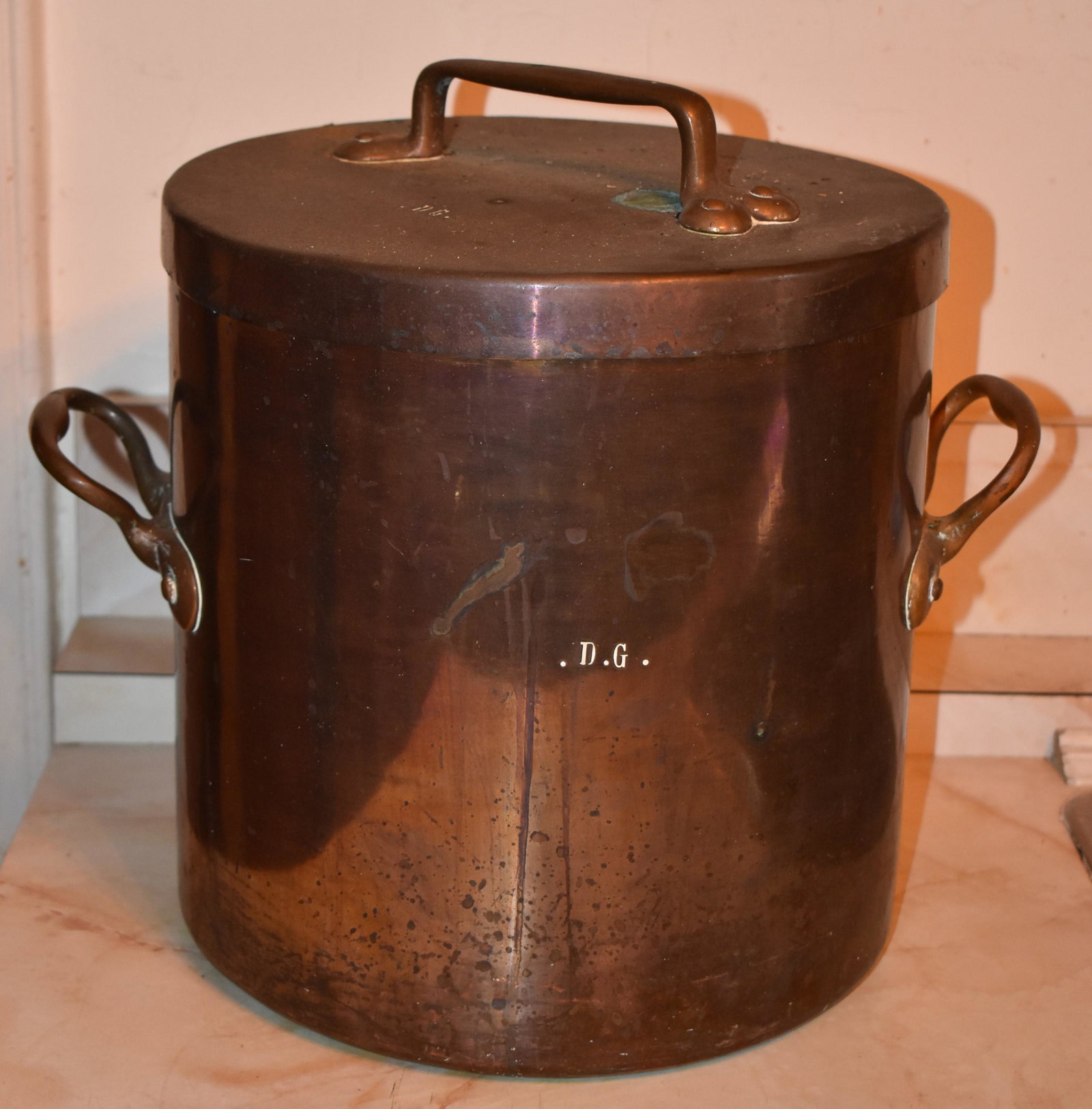 Large French Two Handled Dovetailed Copper Pot: with cover, engraved on body and cover D G. The lid handle with heart terminals. Height 12" Diameter 12" Tinned interior