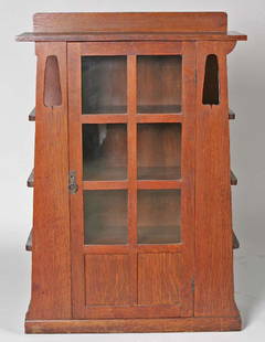 Limberts Arts & Crafts Quartered Oak Bookcase: American Arts and Crafts Quartered Oak Bookcase, fine tapering form with rectangular back splat, carved open worked front centering a six light two paneled door. Case with three shelves on either