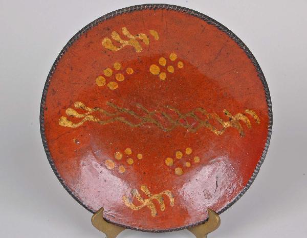 PA Redware Slip Decorated Charger, Dia. 10.5": PA Redware Slip Decorated Charger, Dia. 10.5" having gadrooned border with yellow slip decorated well. Diameter 10 1/2"