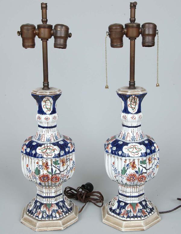 Pair Of Continental Tin Glazed Earthenware Lamps: Pair Of Continental Tin Glazed Earthenware Vases, Now Mounted As Lamps, octagonal reeded Persian influenced Oriental design body with blue and polychrome floral decoration, molded wood base. Ht. Vase