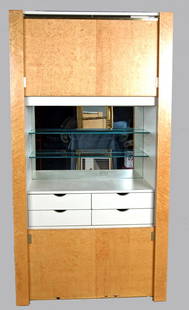 PAUL EVANS BIRD'S EYE MAPLE CABINET with mirrored b: PAUL EVANS BIRD'S EYE MAPLE CABINET with mirrored back and two glass shelves above four drawers. Electric motor operates sliding doors which close cabinet. Original receipt from Dorsey Reading H.