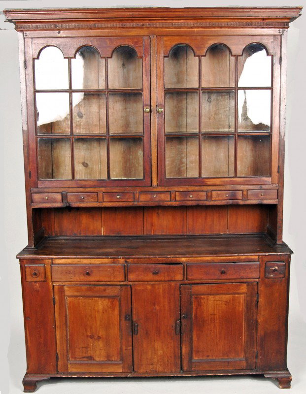 PENNSYLVANIA SOFTWOOD DUTCH CUPBOARD, EARLY 19TH C.: PENNSYLVANIA SOFTWOOD DUTCH CUPBOARD, EARLY 19TH C. , the projecting molded matchstick decorated cornice above two nine light arched glazed doors above a bank of seven drawers, the lower case with lar