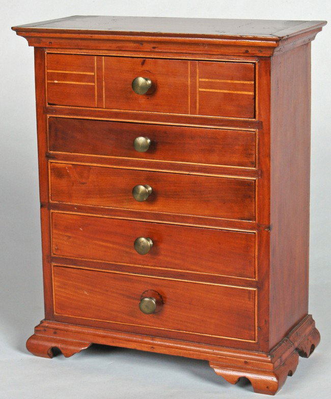 MINIATURE CHIPPENDALE CHERRY TALL CHEST, LATE 18TH : MINIATURE CHIPPENDALE CHERRY TALL CHEST, LATE 18TH C., the case with boxwood string inlay, five graduated drawers and having original ogee bracket feet. Family letter of inquiry to Henniker, NH Histor
