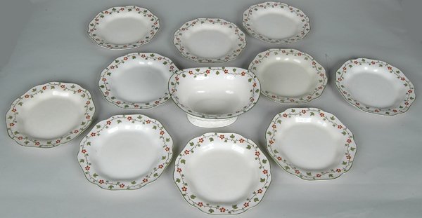 11 PCS WEDGEWOOD CREAMWARE W/VINE & BERRY DECORATI: including 11 shallow soups Dia. 9" and an oval footed bowl. L. 9" Ht. 5" Sotheby Parke Bernet label on base of bowl.