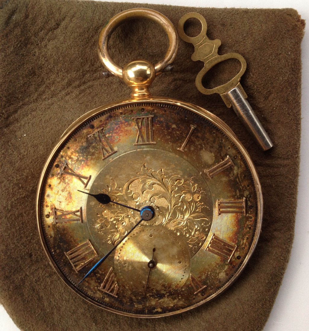 18 KT GOLD MAN'S PATENT LEVER POCKET WATCH: Having bright cut/ engraved acanthus leaf decorated face , with Roman numerals and second hand. Blued steel hands, inside door of case case marked 18K and also AE and the case number 20872 Having appr
