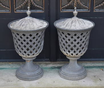 PAIR OF ENGLISH CLASSICAL LEAD GARDEN URNS & COVERS: An exceptional pair of English Classical lead garden urns and covers. The covers with ball finials above a domed fluted base above a basketweave lattice work urn formed body on raised circular foot. H