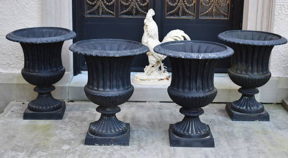 SET OF FOUR CLASSICAL CAMPAGNA FORM GARDEN URNS: The Classical campagna formed garden urns with egg and dart molded rim, fluted and reeded bodies on egg and dart and fluted circular shaft raised on square plinth base. Solid Aluminum. Height 26"