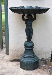 RARE 19TH CENTURY FISKE FIGURAL CAST IRON BIRDBATH: The cast iron bird bath with shell form water reservoir with Classical putti standard on stepped octagonal plinth. Retains old hunter green paint over black. Height 32" Width 21" Depth 13"