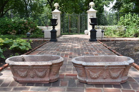 PR OF CLASSICAL DESIGN ROSE PINK CAST STONE PLANTERS: The French-style Classical design cast stone planters of rectangular form with astragal ends. The planters ornamented with cast festoons emanating from central crest, cherub faced ends with cast