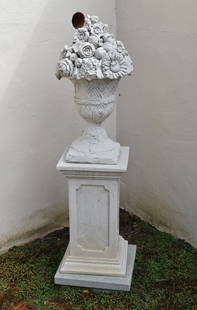 ANTIQUE SCULPTED STONE GARDEN SCULPTURE OF URN: WITH FLOWERS ON PEDESTAL. PEDESTAL OF FAUX STONE. A similar stone basket of fruit is in the 17th century King's vegetable garden in Versailles. Height 51"