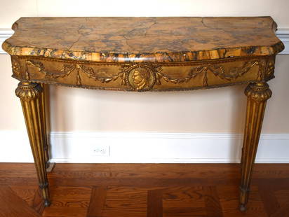 FINE 18TH CENTURY ITALIAN NEOCLASSICAL GILT CONSOLE TABLE: The molded variegated Sienna bowfront marble top with serpentine sides above a conforming frieze with central boss featuring a Roman emperor with bellflower and ribbon decoration resting on four