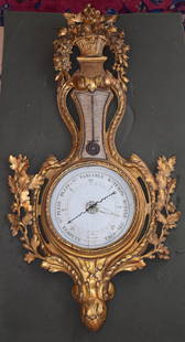 RARE ANTIQUE LOUIS XIV GILTWOOD BAROMETER: The barometer with basket of flowers top above thermometer over circular dial marked "Moreau Rue de Seine St Germain a Paris" flanked by carved oak branches with leaves and acorns with acanthus and ar