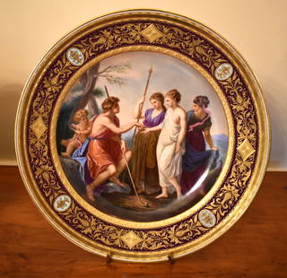 FINE ROYAL VIENNA CABINET PLATE JUDGEMENT OF PARIS: The plate with central handpainted reserve depicting the Judgement of Paris with three maidens and cupid. Fine crimson raised gilt decorated border with urn form medallions. Royal Vienna blue