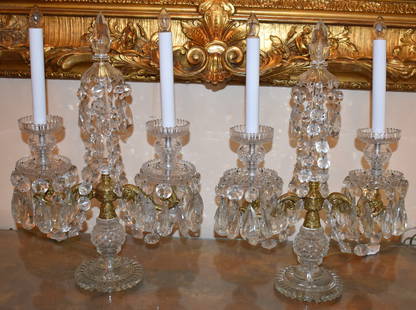 PAIR OF 19TH CENTURY ENGLISH CRYSTAL CANDELABRAS: In the Regency taste, The candelabra with two lights and central spire with drape formed bands of double cut bangles supported by ornate ormolu serpentine scroll arms with diamond cut drip pans and ca