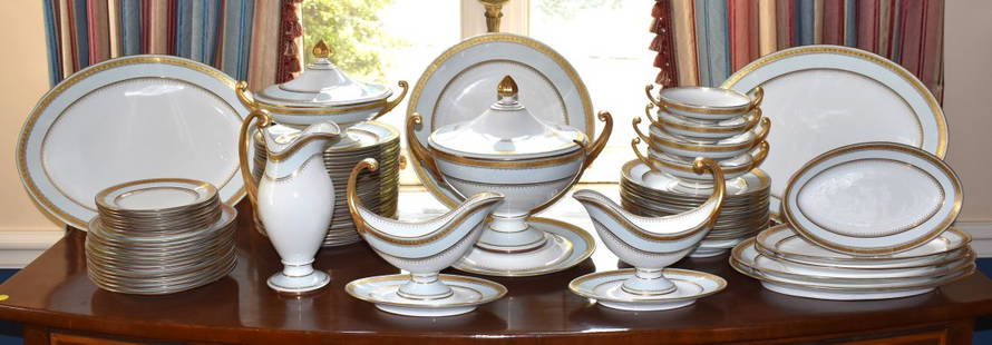 LARGE RORSTRAND SWEDISH PORCELAIN DINNER SERVICE: The Rorstrand service with white reserves with light blue banded and gilt borders. The set consists of 24 dinner plates, 12 soups, 12 luncheon plates, 8 cake plates, 5 graduated platters, 2 large sauc