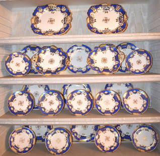 19TH CENTURY ENGLISH PORCELAIN CHINA SERVICE: Of fine quality, the service with blue decorated borders with gilt floral decoration. Consisting of 9 lucheon plates 9 1/4", 11 dessert plates 7" diameter, 2 large leaf shaped serving dishes and 2 lar