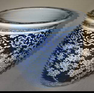 ANTIQUE CHINESE PORCELAIN BLUE & WHITE FISH BOWL: 19TH CENTURY, Having a molded rim with allover prunus blossom hawthorne decorated body. Height 14 1/2" Diameter 15 3/4" Spider crack under base.