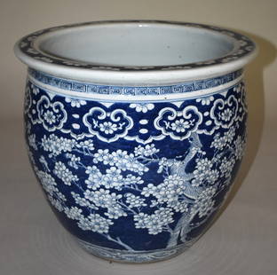 ANTIQUE CHINESE PORCELAIN BLUE & WHITE FISH BOWL: 19TH CENTURY, Having a molded rim with allover prunus blossom hawthorne decorated body. Height 14 1/2" Diameter 15 3/4" Spider crack under base.