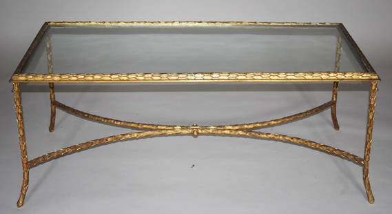 AN EXCEPTIONAL GILT BRONZE GILDED AGE COFFEE TABLE: An exceptional gilt bronze and glass Louis XV coffee table, attributed to P. E. Guerin, New York. Height 17" Width 41 1/4" Depth 19 1/2" In fine condition. No sign of any damage. The legs, stretcher a