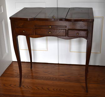 ANTIQUE FRENCH WALNUT LOUIS XV DRESSING TABLE: A very nice antique French Louis XV style walnut dressing table. The top with central fold up mirror and two hinged sides all when lifted reveal a wallpapered sectioned storage well. The case with wri