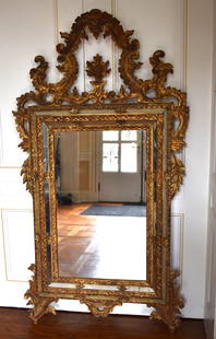 EXCEPTIONAL LARGE ITALIAN GILT CARVED MIRROR: Venetian, 1st half 20th century Height 62 1/2" Width 34 3/4" Provenance: Mr. William C. Robinson Jr was master of foxhounds at the Sewickley Hunt Club and also was owner of the horse farms: "Far Away