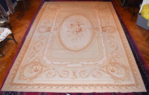 9' 9" X 13' 9" AUBUSSON CARPET: Classic French design with central oval floral medallion set in rectangular field with foliate and acanthus design border. Contemporary