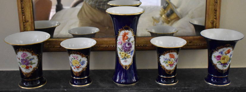 FIVE PIECE MEISSEN COBALT & FLORAL GARNITURE SET: The Meissen garniture set with cobalt ground and handpainted floral reserves. Tallest Vase 9 1/2" Two outer spill vases with repairs.