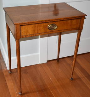 19TH CENTURY AMERICAN TIGER MAPLE SERVING TABLE: The tiger maple serving table with rectangular top above a single drawer fitted with brass oval plate and bale handle on straight turned cabriole legs ending in pad feet. Height 30" Width 25" Depth 16