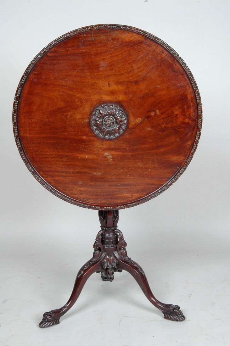 EXCEPTIONAL 18TH C. ENGLISH TEA TABLE: Attributed to the workshop of Thomas Chippendale, the wonderful patinated old growth mahogany top with raised carved central boss and piecrust edge tilting above the most elaborate pierced carved shaf