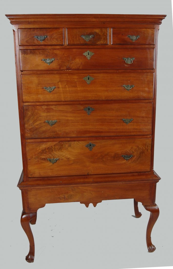 FINE PENNSYLVANIA WALNUT CHEST ON FRAME: 18th century Queen example having a projecting molded cornice with two short drawers over four long drawers flanked by fluted quarter columns, the base with molded top and scalloped skirt resting on c