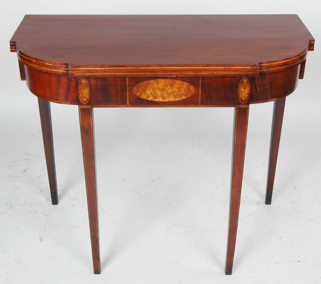 HEPPLEWHITE MAHOGANY CARD TABLE: Modified "D" form with oval banded and string inlay, fourth quarter of the 18th century. H. 29 1/2"