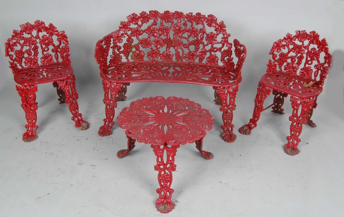 4 PC. VICTORIAN VINTAGE PATTERN GARDEN SET: Having fine red painted surface, consisting of a settee H. 27 1/2, W. 38"; 2 chairs & a low circular table.