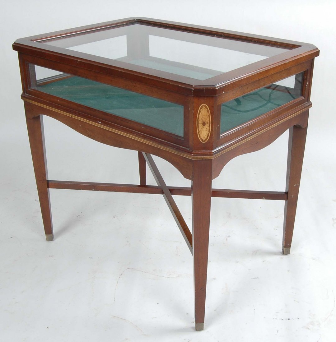 HEPPLEWHITE STYLE MAHOGANY VITRINE: Of rectangular form with lightwood inlay & canted corners, the conforming hinged glazed paneled top above scalloped skirt resting on four tapering legs fitted with cross stretchers. H. 24 1/2"; W. 26"