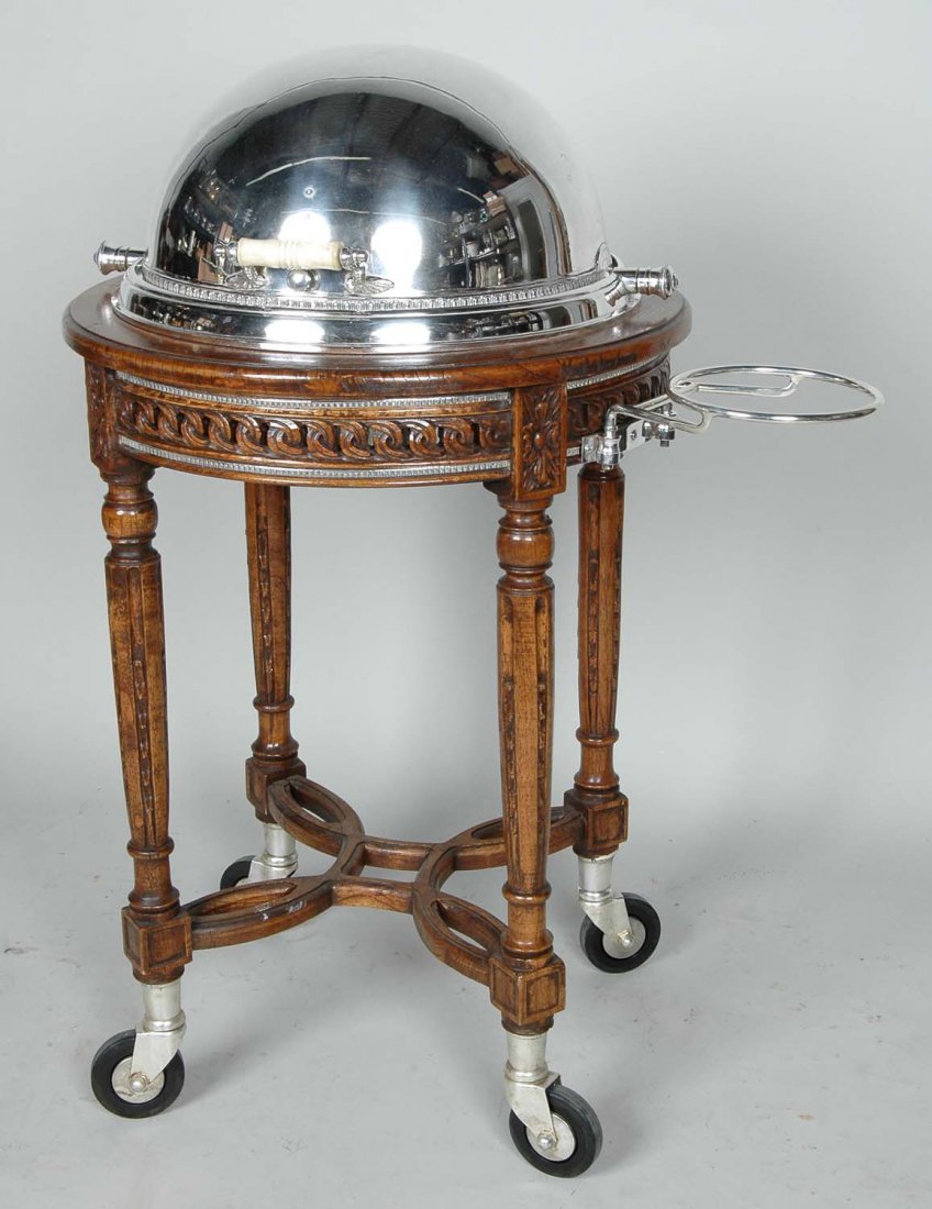 EXCEPTIONAL LOUIS XVI STYLE WALNUT SERVING TROLLEY: Louis XVI-Style Mahogany and Sheffield-Mounted Serving Trolley, with a roller dome in the center, the base with silver-gilt mounts, h. 44", w. 35", d. 26".