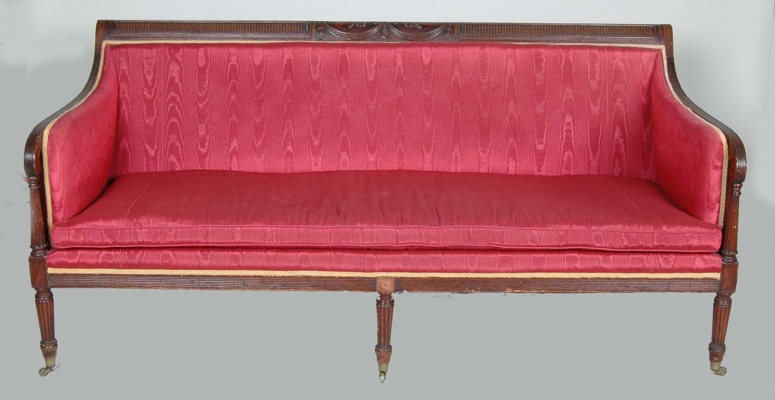 19TH C. NEW YORK FEDERAL MAHOGANY SOFA: In the manner of Duncan Phyfe, with drapery swag carved crest rail, reeded sweeping arms, arm supports, skirt and tapering turned legs fitted with original brass casters and ferrules. Ht. W. D.