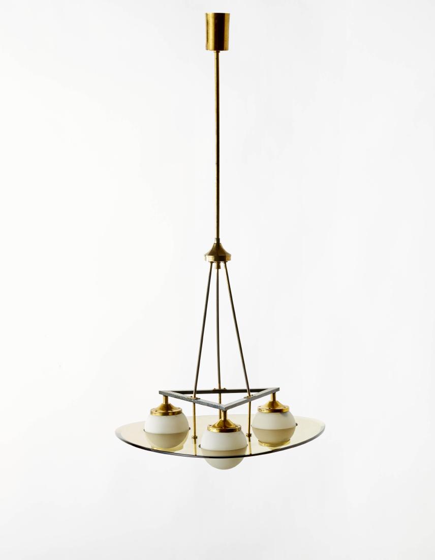 Three lights suspension lamp with structure in rod and: Three lights suspension lamp with structure in rod and tubular of polished brass and painted black. Triangular shaped disc rounded with amber-polished- glass, diffusing globes in incamiciato lattimo g