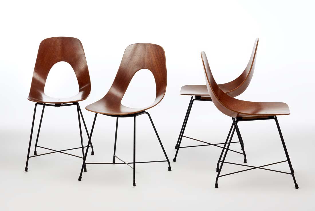 Augusto Bozzi (1924 - 1982) Four chairs. Produced by: Augusto Bozzi (1924 - 1982) Four chairs. Produced by Saporiti, Besnate, 1957. Black painted metal structure, curved teak plywood. Bearing the production's label. (40.5x81x54.5 cm.) (slight defects and