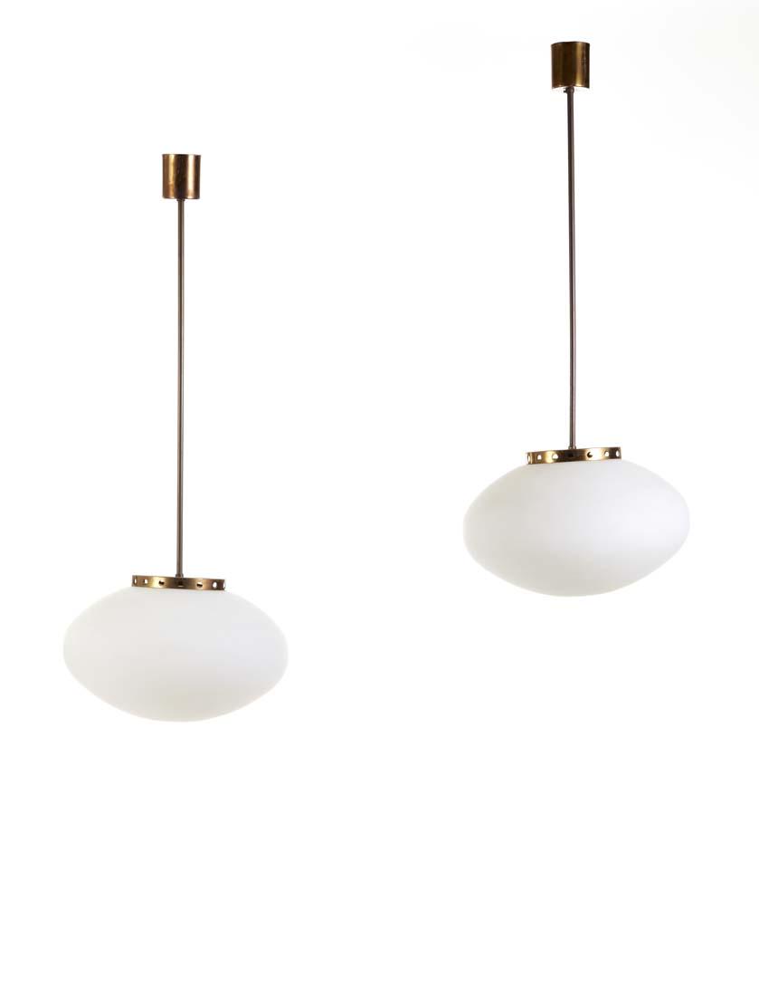 Pair of suspension lamps with flattened diffuser in: Pair of suspension lamps with flattened diffuser in lattimo incamiciato glass, brass structure. Italy, 1950s. (h 95 cm.) (slight defects) IT Coppia di lampade a sospensione con diffusore di forma schi