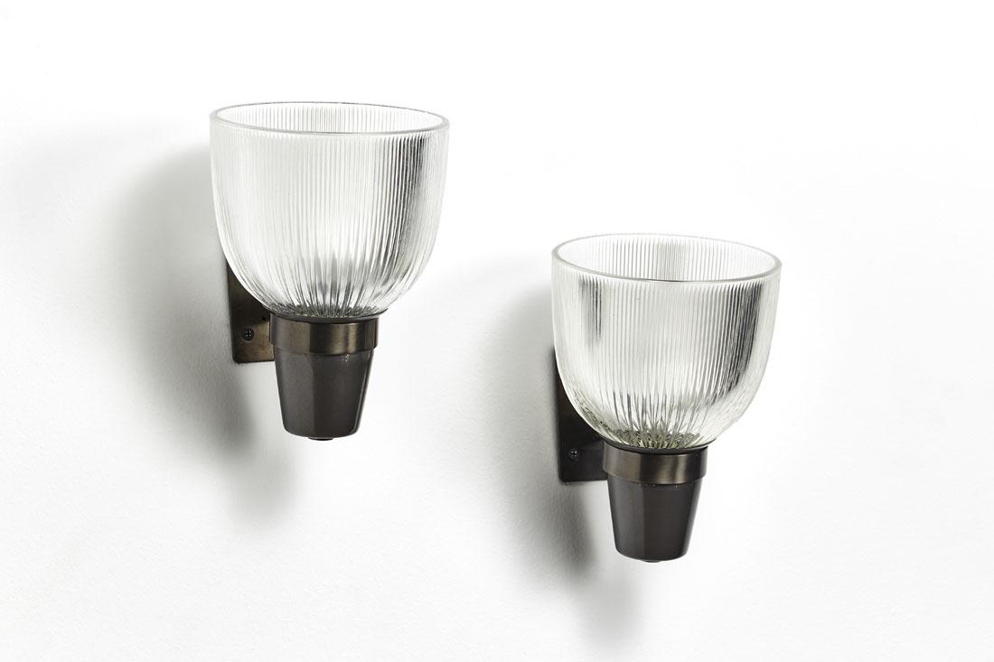 Ignazio Gardella e Corrado Corradi Dell'Acqua Pair of: Ignazio Gardella e Corrado Corradi Dell'Acqua Pair of wall lamps model "LP5 Coppa vetro aperta". Produced by Azucena, Milan, 1954. Pressed glass diffuser, structure in burnished brass and gray painted