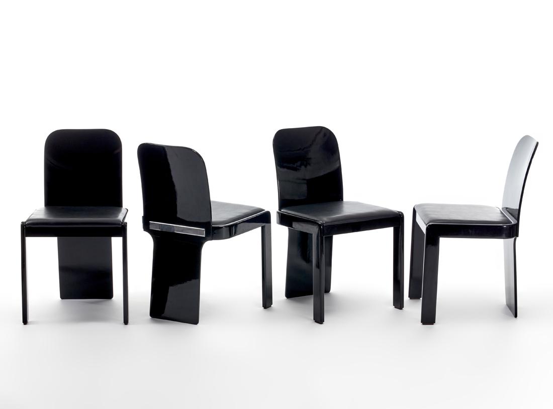 Pierluigi Molinari (Milano 1938) Four chairs. Produced: Pierluigi Molinari (Milano 1938) Four chairs. Produced by Pozzi, Italy, 1970s/1980s. Black lacquered wood with chromed metal plate on the back, seat in black fake leather. (47x80x54 cm.) (slight defec