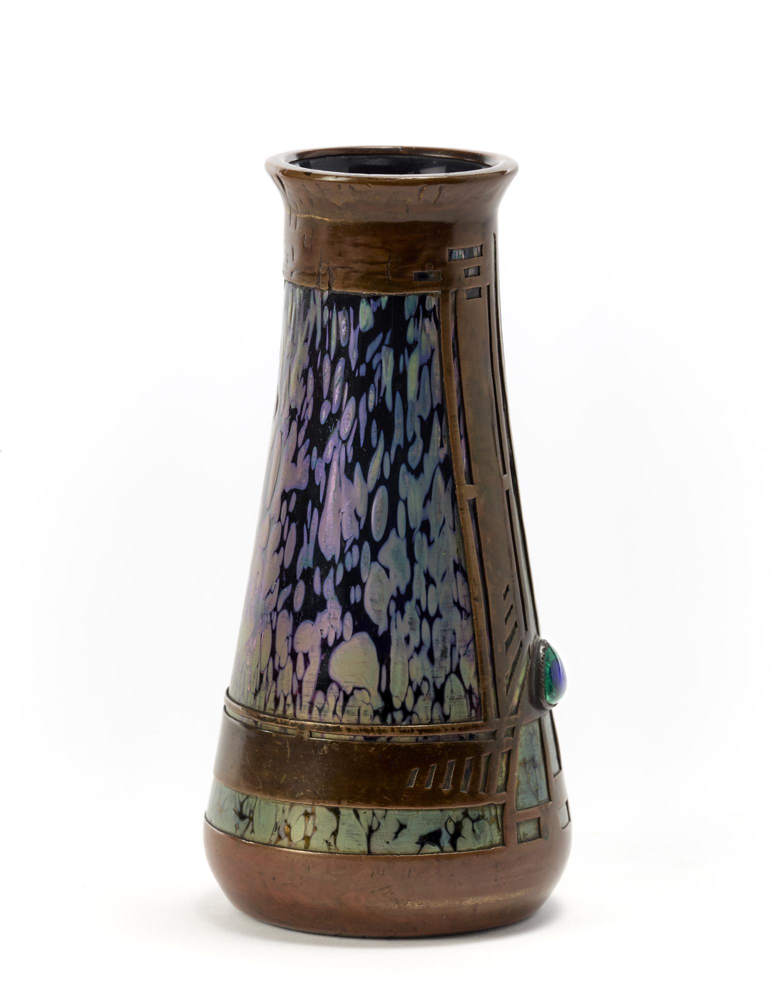 Koloman Moser (Vienna 1868 - Vienna 1918) (Attributed) Dark amethyst glass vase with iridescent: Koloman Moser (Vienna 1868 - Vienna 1918) (Attributed) Dark amethyst glass vase with iridescent green spots, copper frame embellished with peacock eye cabochon. Execution by Loetz, Austria, early 20th