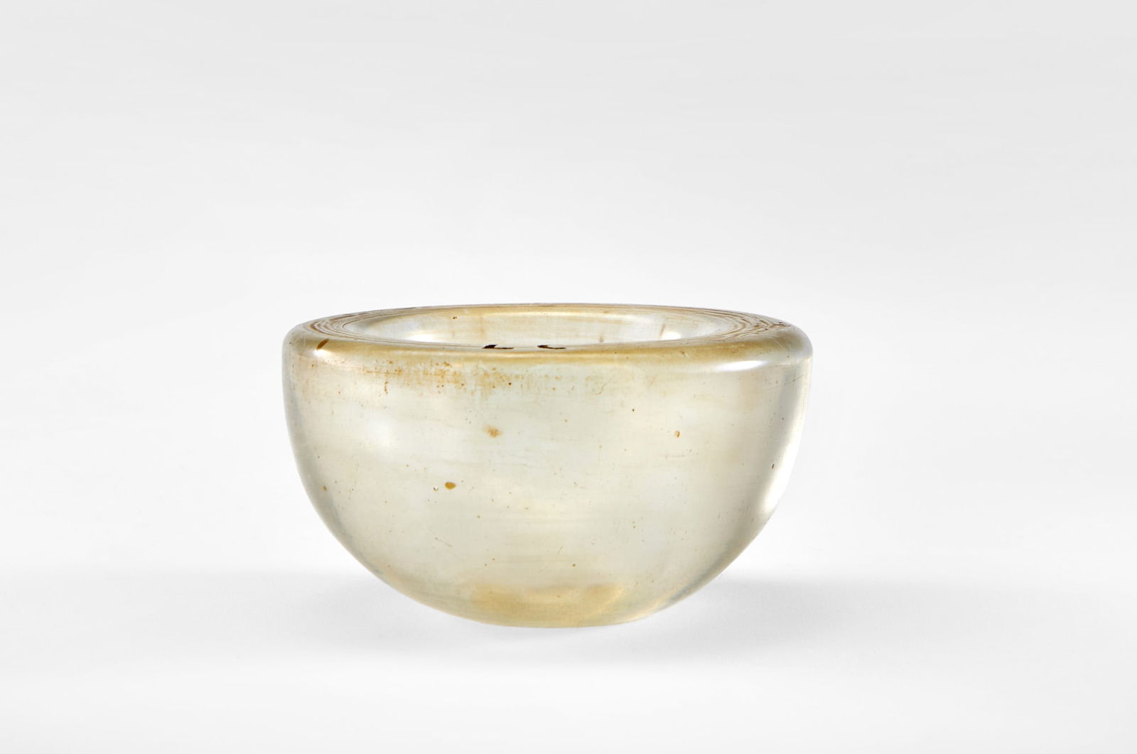 Carlo Scarpa (Venezia 1906 - Sendai 1978) Small bowl in transparent submerged glass, strongly: Carlo Scarpa (Venezia 1906 - Sendai 1978) Small bowl in transparent submerged glass, strongly iridescent on the outer surface. Venini, Murano, 1930s. Signed with the initials L. C. on the rim and acid