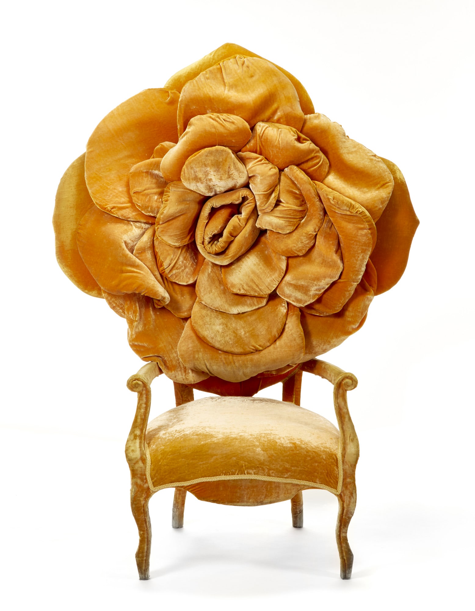 Carla Tolomeo (Pinerolo 1941) Armchair with large floral decoration on the backrest model "Rosa".: Carla Tolomeo (Pinerolo 1941) Armchair with large floral decoration on the backrest model "Rosa". Italy, 2000s. Wooden frame covered in orange velvet. Bearing designer's metal label on the back. (130x