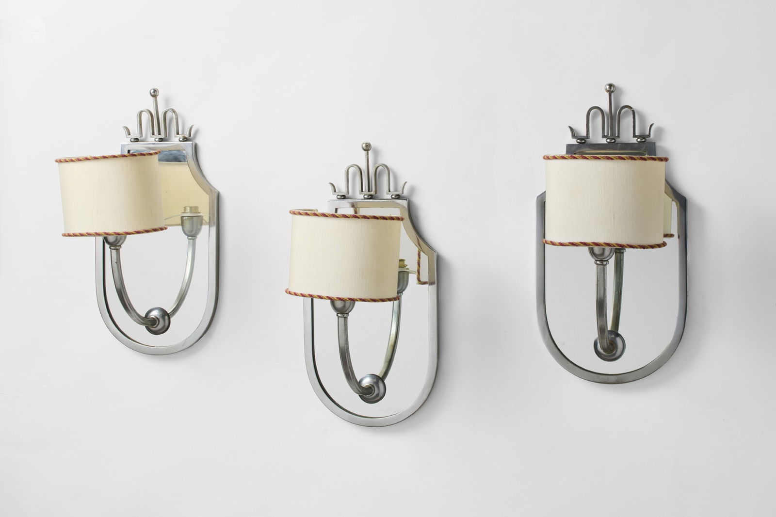 Three Novecento style small mirrors. Milan, 1930ca. Nickel-plated brass, non-coeval fabric (1 of 2)