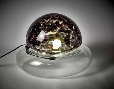 Gae Aulenti (Palazzolo Dello Stella 1927 - Milano 2012) Table lamp model "Poveglia". Execution by: Gae Aulenti (Palazzolo Dello Stella 1927 - Milano 2012) Table lamp model "Poveglia". Execution by Vistosi, Italy, 1970s. Two colourless and smoked blown glass elements with amethyst and green murrine.