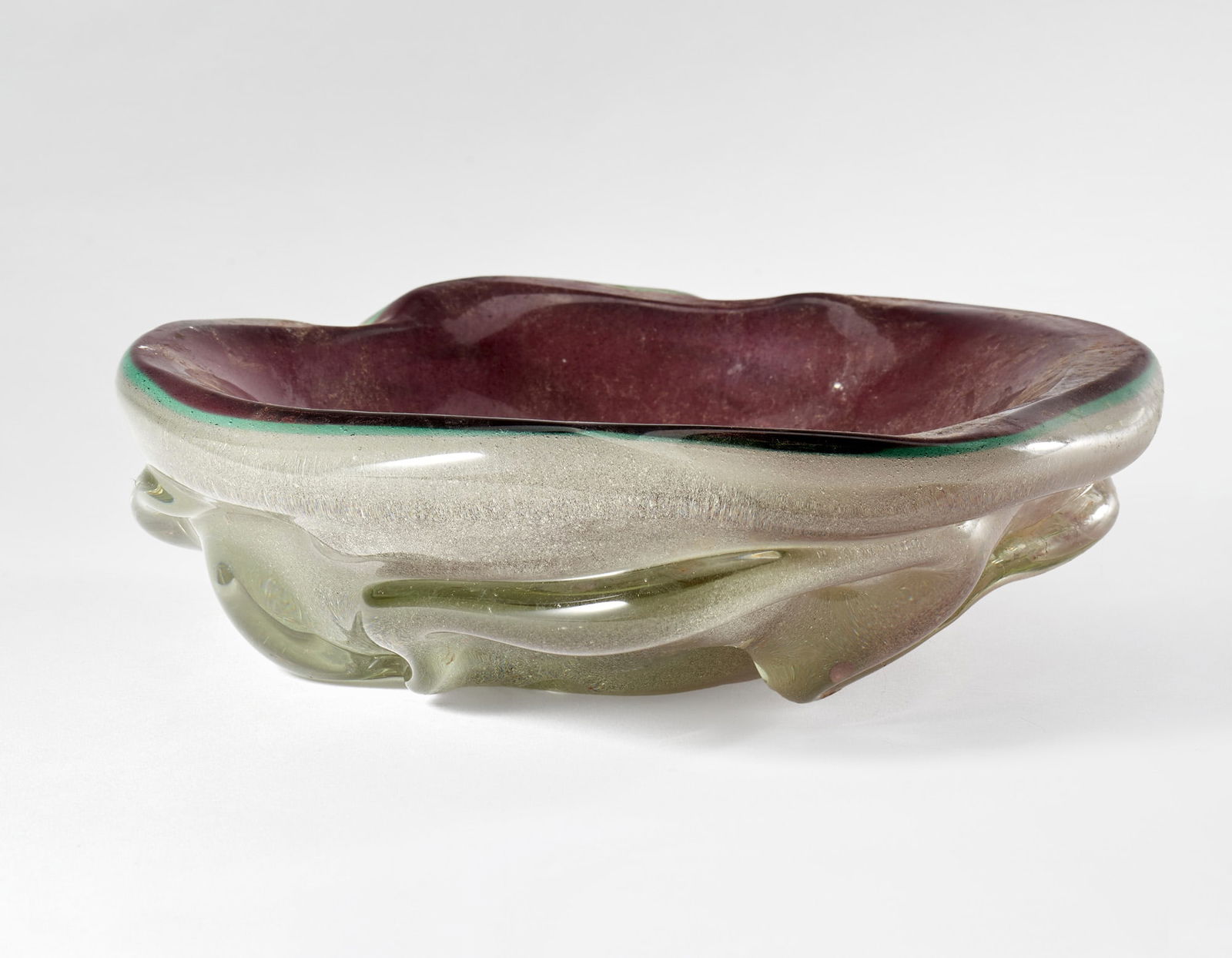 Seguso Vetri d'Arte Transparent aqua green and amethyst sommerso glass pocket emptier with bubbles.: Seguso Vetri d'Arte Transparent aqua green and amethyst sommerso glass pocket emptier with bubbles. Murano, 1930s. (d 22 cm.) Provenance Private collection, Ferrara IT Svuotatasche in vetro sommerso c