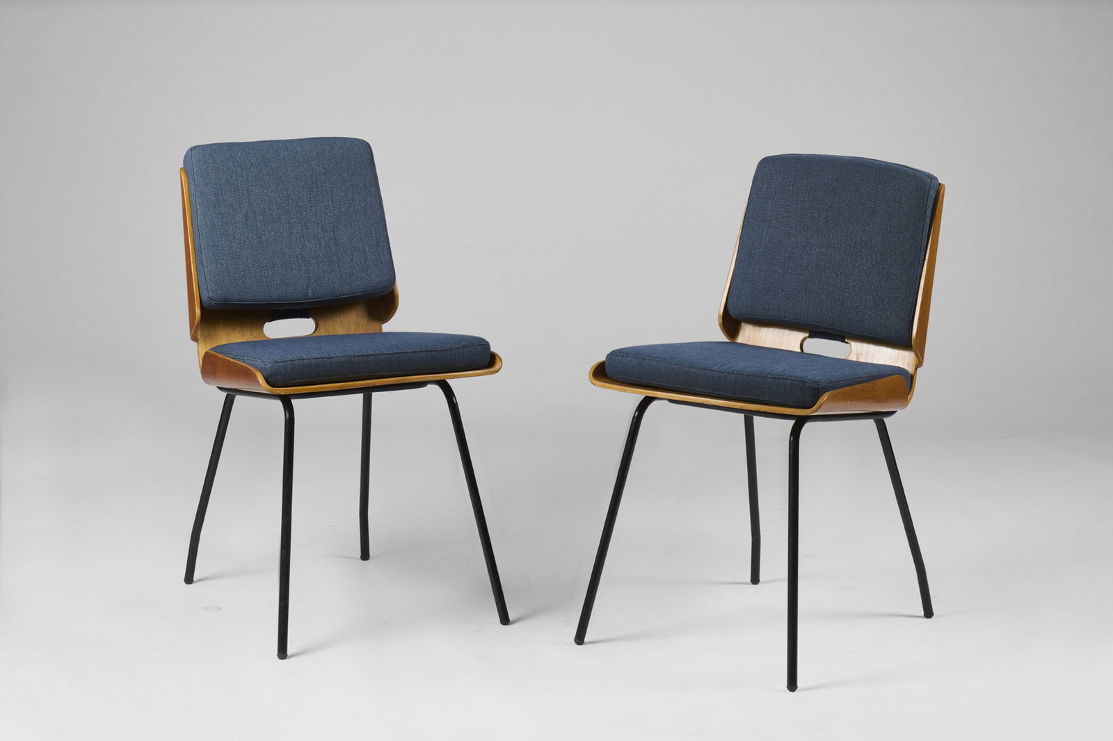 Giancarlo De Carlo (Genova 1919 - Milano 2005) Pair of small armchairs model "Lucania". Produced by: Giancarlo De Carlo (Genova 1919 - Milano 2005) Pair of small armchairs model "Lucania". Produced by Arflex, Milan, 1954. Black painted iron rod legs, plywood seat and backrest, cushions with blue fabr