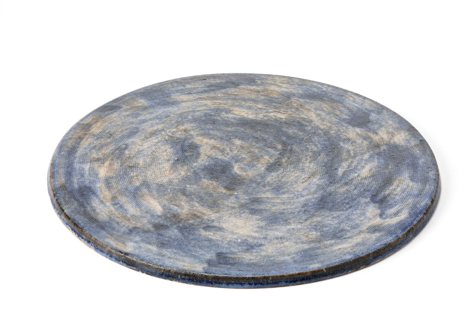 Bruno Gambone (Vietri Sul Mare 1936 - Firenze 2021) Glazed ceramic disc in shades of blue, white and: Bruno Gambone (Vietri Sul Mare 1936 - Firenze 2021) Glazed ceramic disc in shades of blue, white and brown, with a ribbed engraved surface on top. Italy, 1970s/1980s. Signed under the base. (d 37 cm.)