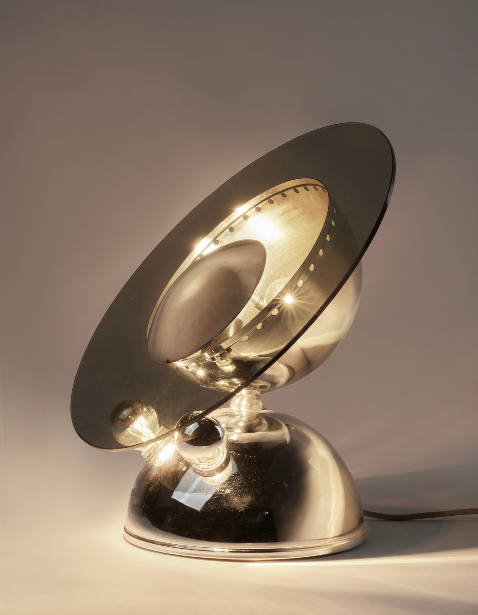 Chrome-plated aluminium table lamp with smoked glass disc. Italy, 1970s. (h 38 cm.; d 39 cm.) (1 of 4)