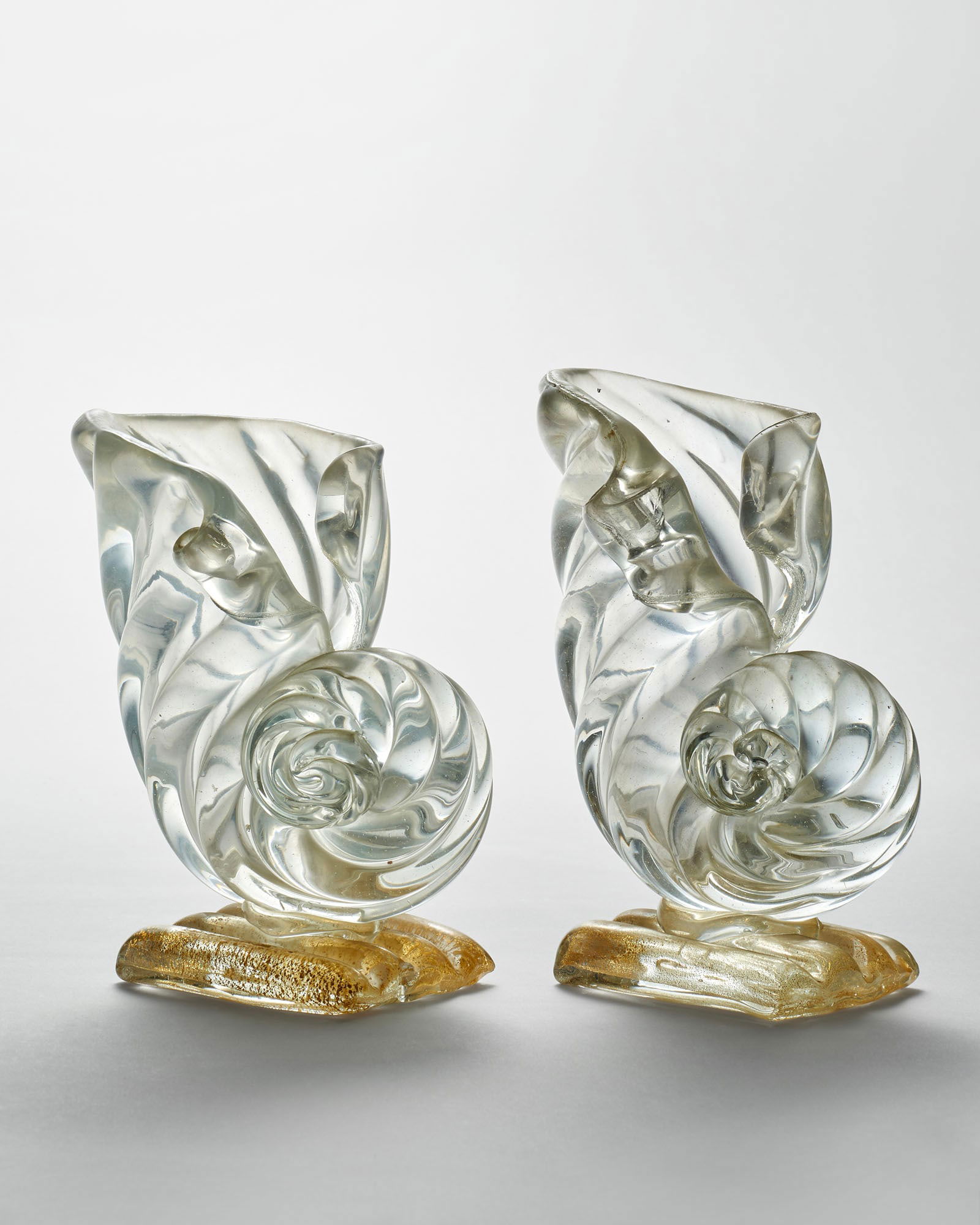 Flavio Poli (Chioggia 1900 - Venezia 1984) (Attributed) Two shell-shaped vases in blown crystal: Flavio Poli (Chioggia 1900 - Venezia 1984) (Attributed) Two shell-shaped vases in blown crystal glass with a slightly iridescent surface, ribbed base with gold leaf application. Execution by Seguso Ve